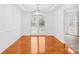 Elegant dining room boasts hardwood floors, decorative lighting, and glass doors leading to the backyard at 13705 Queenswater Ln, Charlotte, NC 28273