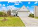 White home with a well-kept lawn, attached garage, and a charming entrance at 13705 Queenswater Ln, Charlotte, NC 28273