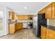 Functional kitchen with stainless steel appliances and wooden cabinets at 13705 Queenswater Ln, Charlotte, NC 28273