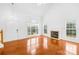 Bright living room with large windows, a fireplace, and gleaming hardwood floors at 13705 Queenswater Ln, Charlotte, NC 28273