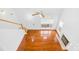 Open living room with hardwood floors, stairs, a fireplace, and plenty of natural light from multiple windows at 13705 Queenswater Ln, Charlotte, NC 28273