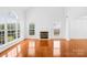 Bright living room with large windows, a fireplace and beautiful hardwood floors at 13705 Queenswater Ln, Charlotte, NC 28273