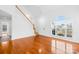 Bright living room showcasing hardwood floors, stairs to the second floor and a large window at 13705 Queenswater Ln, Charlotte, NC 28273