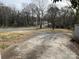Spacious backyard featuring a large parking area and mature trees, ideal for outdoor activities at 1408 Linwood Rd, Gastonia, NC 28052