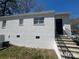 Charming white brick house showcasing a new exterior paint and updated windows and front door at 1408 Linwood Rd, Gastonia, NC 28052