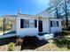 Charming, painted brick home featuring black shutters, and inviting porch at 1408 Linwood Rd, Gastonia, NC 28052
