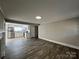 Open-concept living room with hardwood floors, and a seamless flow to kitchen at 1408 Linwood Rd, Gastonia, NC 28052