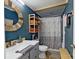 Stylish bathroom with modern vanity, and wooden shelves, showcasing a clean and contemporary design at 162 Dogwood Cir, New London, NC 28127