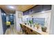 Dining area with window overlooking green space, wood laminate floors, and natural decor at 162 Dogwood Cir, New London, NC 28127