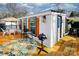 Charming home exterior featuring a patio with an umbrella, table, and grill for outdoor entertaining at 162 Dogwood Cir, New London, NC 28127