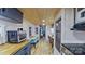 Open-concept kitchen with eat-in bar, stainless appliances, and modern finishes at 162 Dogwood Cir, New London, NC 28127
