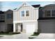 Charming home with a two-car garage, grey siding, and well-manicured landscaping at 1732 Braemar Village Dr, Monroe, NC 28110