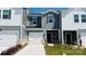 Charming townhome featuring a one-car garage and welcoming, landscaped front yard at 1734 Braemar Village Dr, Monroe, NC 28110