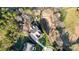 Aerial view of a luxury home with a well-manicured lawn and wooded surroundings at 215 Wesley Manor Dr, Matthews, NC 28104