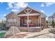 A brick two-story home with a covered patio and paver patio at 215 Wesley Manor Dr, Matthews, NC 28104