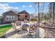 Paver patio featuring a fire pit, outdoor seating, lush landscaping, and a covered patio at 215 Wesley Manor Dr, Matthews, NC 28104