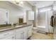 A large bathroom features a granite countertop, white cabinets, a shower, and a large mirror at 215 Wesley Manor Dr, Matthews, NC 28104
