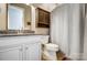 This bathroom features a granite countertop, white cabinets, and a shower with a patterned curtain at 215 Wesley Manor Dr, Matthews, NC 28104