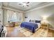 Inviting bedroom with a tray ceiling, a patterned rug, and ample natural light from large windows at 215 Wesley Manor Dr, Matthews, NC 28104