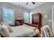 This bedroom showcases hardwood floors, two windows, and a decorative chair at 215 Wesley Manor Dr, Matthews, NC 28104