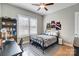 Bedroom with ceiling fan, hardwood floors, modern decor, and natural light from the shuttered windows at 215 Wesley Manor Dr, Matthews, NC 28104