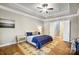 Serene bedroom features a tray ceiling, soft lighting, and easy access to a staircase at 215 Wesley Manor Dr, Matthews, NC 28104
