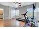 This exercise room is complete with a treadmill, two windows, and hardwood floors at 215 Wesley Manor Dr, Matthews, NC 28104