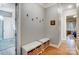 Hallway with hardwood floors, bench seats, storage baskets and decor at 215 Wesley Manor Dr, Matthews, NC 28104