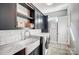 Laundry room with marble countertops, tile backsplash, stainless faucet and sink, and stacked appliances at 215 Wesley Manor Dr, Matthews, NC 28104