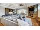 Open-concept living room with fireplace, built-in bar, coffered ceiling, and seamless dining area access at 215 Wesley Manor Dr, Matthews, NC 28104