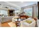 Cozy living room with a stone fireplace, hardwood floors, and comfortable seating at 215 Wesley Manor Dr, Matthews, NC 28104