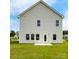Exterior view of back of home features large windows, back door, and spacious yard at 2223 Catawba Trace Dr, Catawba, NC 28609