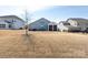 Large backyard with a well-kept lawn, mature tree, and partially-covered patio at 2296 Idol Rock Dr, Indian Land, SC 29707