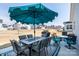 Backyard with an outdoor dining set under a large blue umbrella at 2296 Idol Rock Dr, Indian Land, SC 29707