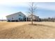 Expansive backyard featuring a well-maintained lawn, patio, and fenced border at 2296 Idol Rock Dr, Indian Land, SC 29707