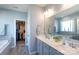 Spacious bathroom with double vanity, soaking tub, and a walk-in closet for ample storage at 2296 Idol Rock Dr, Indian Land, SC 29707