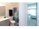 Clean bathroom with a decorative shower curtain, soft grey cabinets and updated hardware at 2296 Idol Rock Dr, Indian Land, SC 29707