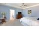 Bright primary bedroom with hardwood floors and a view into the ensuite bathroom at 2296 Idol Rock Dr, Indian Land, SC 29707