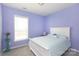 Bright bedroom with lavender walls, complemented by white trim and ample natural light from the window at 2296 Idol Rock Dr, Indian Land, SC 29707
