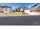 A beautifully landscaped home with a stone facade, a two-car garage, and a welcoming entrance at 2296 Idol Rock Dr, Indian Land, SC 29707