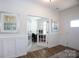 Inviting foyer featuring wainscoting, hardwood floors, and glass french doors opening to a bright office space at 2296 Idol Rock Dr, Indian Land, SC 29707