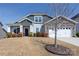 Charming home featuring stone accents, a two-car garage, and inviting front porch with manicured landscaping at 2296 Idol Rock Dr, Indian Land, SC 29707