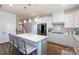 Open kitchen features a large center island with bar seating, stainless appliances, and custom cabinets at 2296 Idol Rock Dr, Indian Land, SC 29707