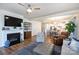 Open-concept living room featuring a fireplace, hardwood floors, and lots of natural light at 2296 Idol Rock Dr, Indian Land, SC 29707