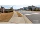 Street view showing a well-maintained neighborhood with sidewalks and landscaped yards at 2296 Idol Rock Dr, Indian Land, SC 29707