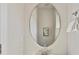 The bathroom is equipped with a stylish oval mirror, modern fixtures, and a towel rack for convenience at 2610 Greenmarket Dr, Charlotte, NC 28217