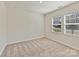 Bright bedroom with neutral carpet, two windows, and ample natural light streaming through the blinds at 2610 Greenmarket Dr, Charlotte, NC 28217