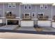 Exterior view of townhome featuring attached garages and balconies at 2610 Greenmarket Dr, Charlotte, NC 28217