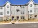 Attractive townhome exterior showcasing a mix of gray siding and brick accents at 2610 Greenmarket Dr, Charlotte, NC 28217