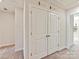 Upstairs hallway featuring carpet and white doors, leading to additional living spaces at 2610 Greenmarket Dr, Charlotte, NC 28217